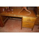 An early 20th Century oak desk, with inset writing surface and two drawers 77cm high, 152cm wide