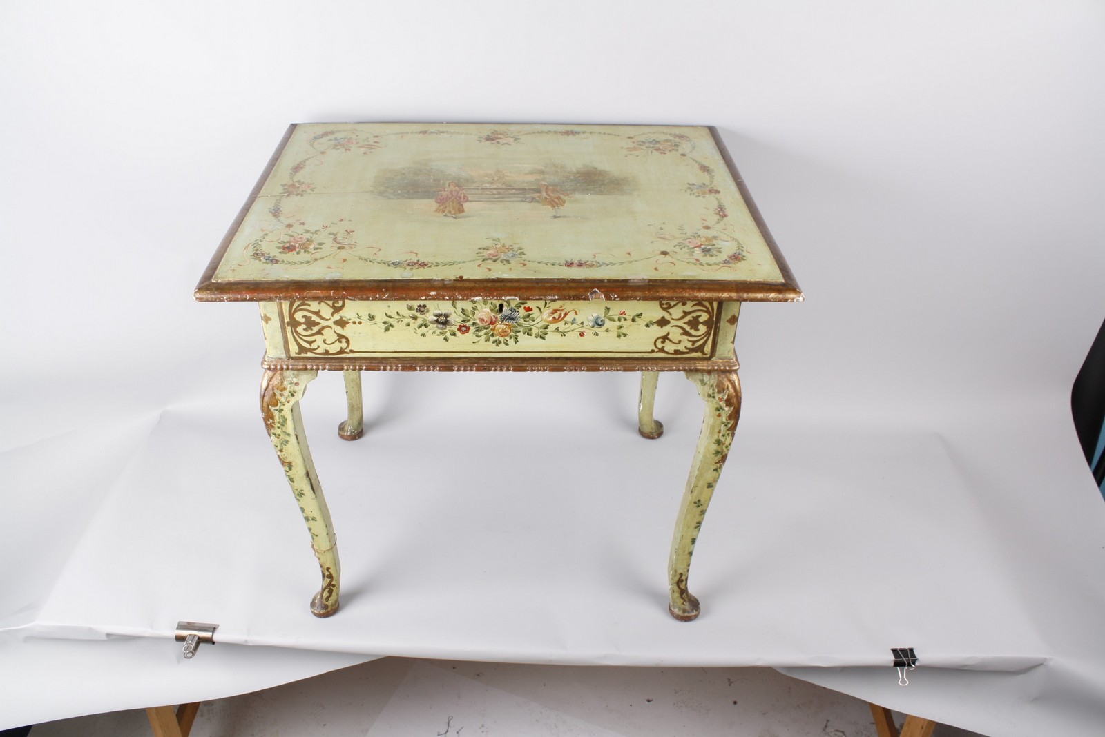 A Regency lowboy with green painted finish and romantic pastoral scene 82cm wide