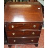 A George III style mahogany desk, with a sloping fall, three long drawers on bracket feet 71cm