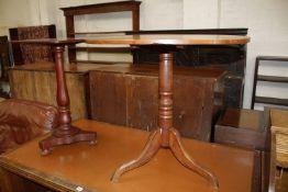 An oak circular occasional table, with turned column and splayed legs together with a further