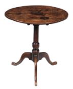 An oak tripod table, early 18th century, the oval tilt top above turned stem and tripod base, 71cm