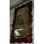 A shaped rectangular painted mahogany wall mirror, decorated with small flowers, 121cm high, 75cm