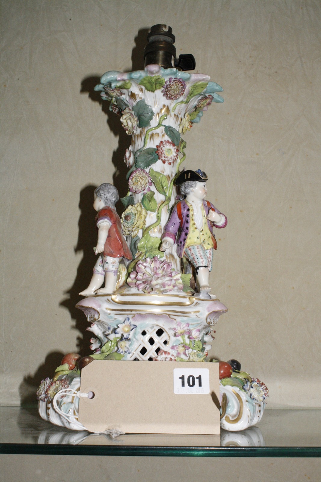 A Dresden porcelain table lamp, floral encrusted, with figures of children, 40cm high approx.