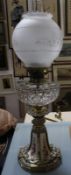 A glass oil lamp, with brass and ceramic shaped base, 65cm high approx.