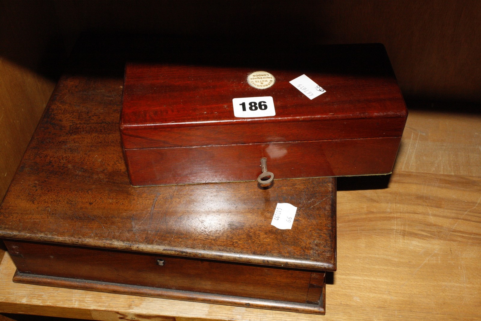 Two billiard balls in a mahogany fitted case by Burroughs & Watts Ltd, Soho Square, London (one