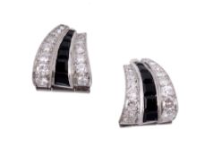A pair of diamond and onyx ear clips, the slightly curved panels set with a...  A pair of diamond