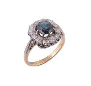 A sapphire and diamond cluster ring, the central oval shaped sapphire claw...  A sapphire and