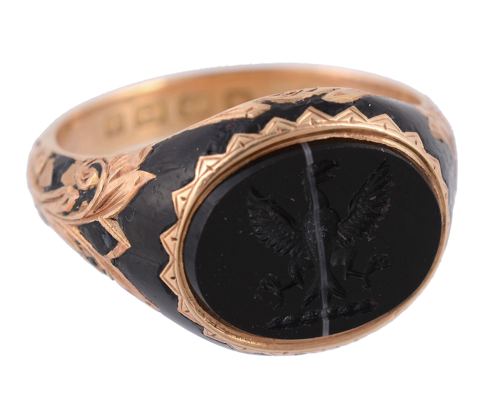 An 18 carat gold onyx signet ring, the oval banded onyx carved with a crest  An 18 carat gold onyx