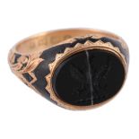 An 18 carat gold onyx signet ring, the oval banded onyx carved with a crest  An 18 carat gold onyx