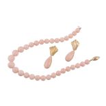 A coral bead necklace, the graduated polished coral beads on a string to a...  A coral bead