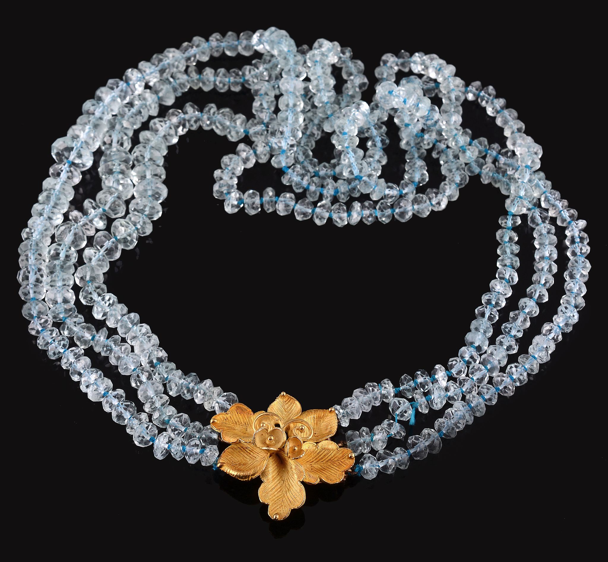 An aquamarine bead necklace, composed of three strands of faceted aquamarine...  An aquamarine