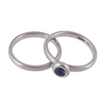A platinum and sapphire ring, the circular shaped sapphire in a collet setting  A platinum and