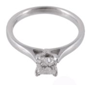 A diamond ring, the princess cut diamond in a four claw setting, stamped 750  A diamond ring,