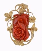 A coral rose brooch, the coral carved as a rose head within a textured...  A coral rose brooch,