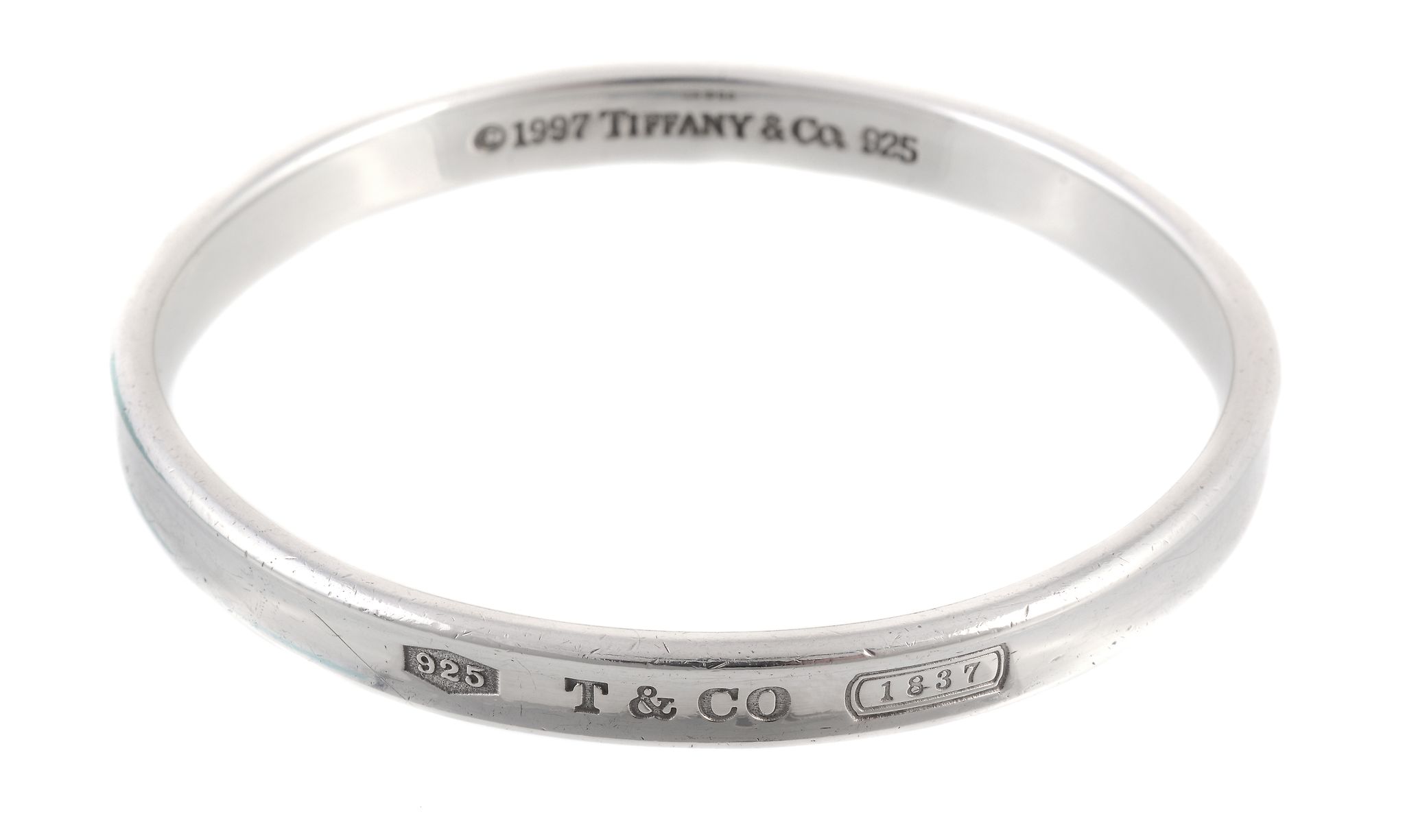 A silver bangle by Tiffany and Co., the bangle signed 1997, stamped 925  A silver bangle by - Image 2 of 2