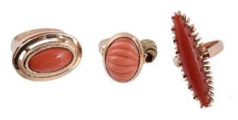 A coral ring, the oval shaped cabochon coral within a collet setting  A coral ring,   the oval