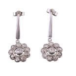 A pair of diamond ear pendents, the central old cut diamond in a cut down...  A pair of diamond