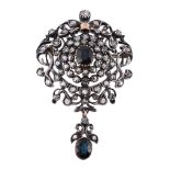 A sapphire and diamond brooch, the central oval shaped sapphire claw set...  A sapphire and