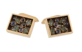 A pair of sapphire and emerald cufflinks, the rectangular panels set with...  A pair of sapphire and