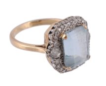 An aquamarine and diamond cluster ring, the central rectangular step cut...  An aquamarine and