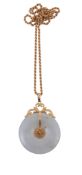 A jadeite pendant, the circular shaped polished jadeite pendant with central...  A jadeite pendant,