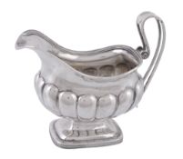 A Dutch silver oblong baluster pedestal cream jug, date letter for 1838  A Dutch silver oblong