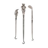 Three silver novelty handled button hooks, to include  Three silver novelty handled button