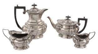 An Edwardian silver four piece lobed oblong baluster tea service by John Hines  An Edwardian