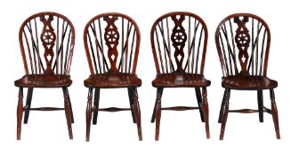 A set of four yew and elm wheel back windsor chairs , 19th century  A set of four yew and elm