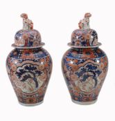 A Pair of Imari Vases and Covers, each of inverted baluster form with a...  A Pair of Imari Vases