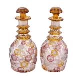 A pair of clear glass, engraved and yellow and pink-flashed decanters and...  A pair of clear glass,