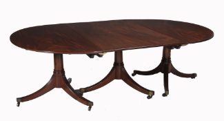 A mahogany triple pedestal extending dining table  A mahogany triple pedestal extending dining