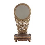 A Chinese red and gilt carbed wood table mirror on a stand, 66cm high  A Chinese red and gilt carbed