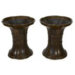 A pair of bronze archaic style vases, the five lobed bodies with flared foot...  A pair of bronze