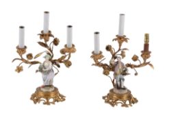 A pair of Meissen porcelain gilt-metal-mounted figural three-branch candelabra  A pair of Meissen