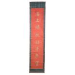 A pair of Chinese red silk calligraphic scrolls  A pair of Chinese red silk calligraphic