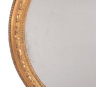 A Victorian carved gilt wood oval wall mirror, circa1900  A Victorian carved gilt wood oval wall