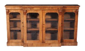 A Victorian walnut breakfront display cabinet , circa 1860  A Victorian walnut breakfront display