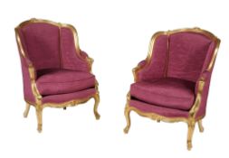 A pair of upholstered and giltwood framed armchairs in Louis XVI style  A pair of upholstered and