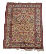 A Kashan rug, the ivory field decorated in polychrome with a flowering urn  A Kashan rug,   the