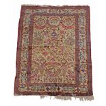 A Kashan rug, the ivory field decorated in polychrome with a flowering urn  A Kashan rug,   the