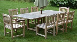 A hardwood draw leaf extending garden table, of recent manufacture  A hardwood draw leaf extending