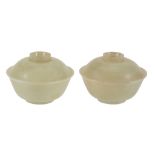 A pair of pale celadon jade bowls and covers , of flared circular shape  A pair of pale celadon jade