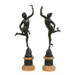 A pair of Continental patinated bronze and marble mounted models of Mercury...  A pair of