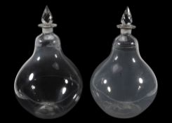 A pair of glass pear-shaped carboys, 19th century, with facetted spire stoppers  A pair of glass