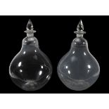 A pair of glass pear-shaped carboys, 19th century, with facetted spire stoppers  A pair of glass