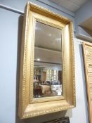 A William IV giltwood wall mirror, circa 1835, the rectangular plate within a moulded frame