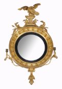 A Regency giltwood and composition convex girandole wall mirror, circa 1815  A Regency giltwood