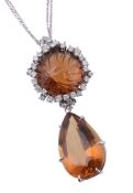 A citrine and diamond pendant, the pendant with circular cabochon citrine...  A citrine and