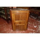 A 19th century mahogany corner cupboard with blind dentil frieze 78cm wide